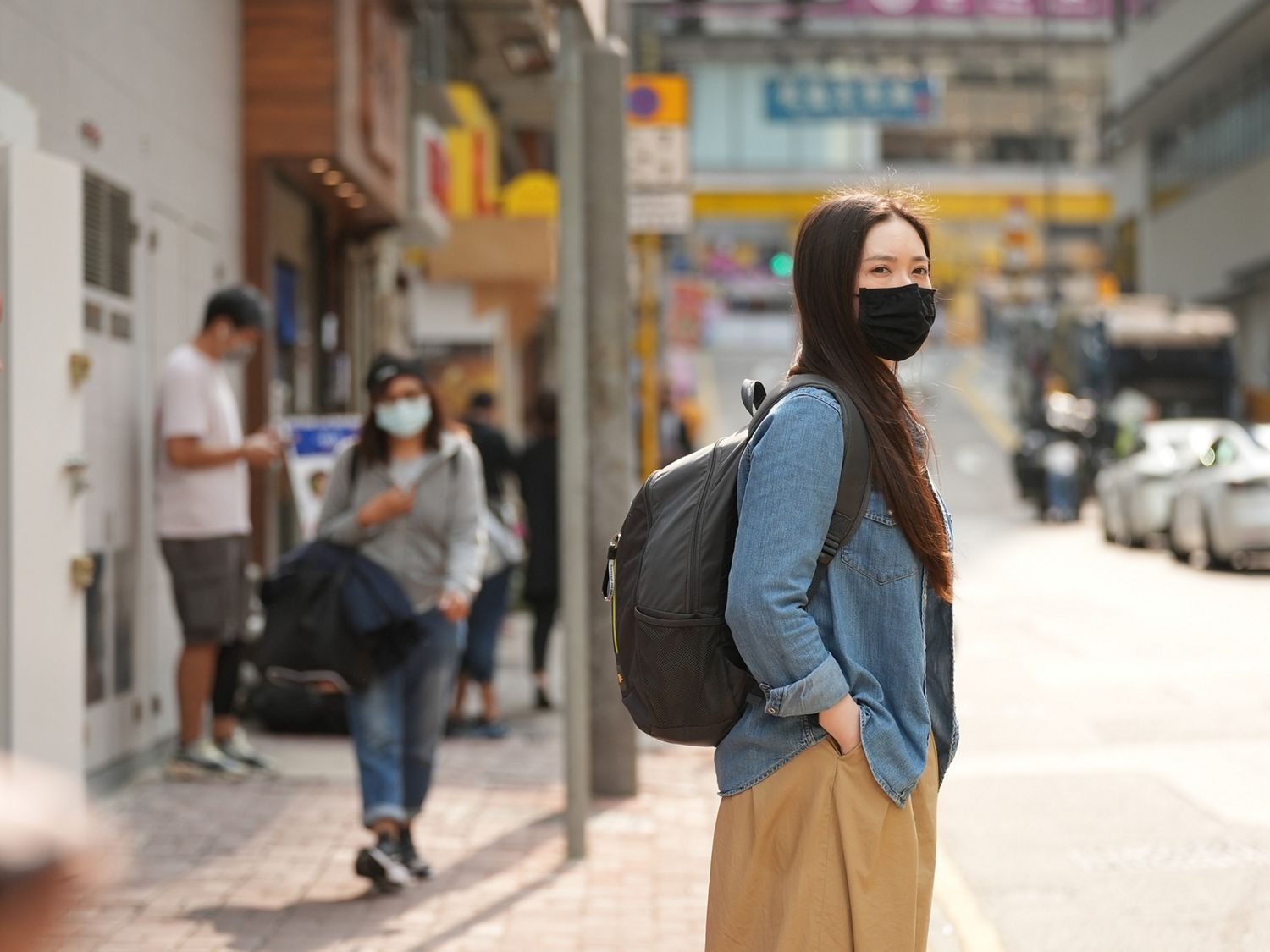 Melody Cheng waits for the bus.